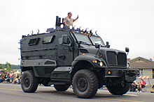 An International MaxxPro vehicle, in gray and with Kitsap County Sheriff's Office SWAT markings at a local parade.