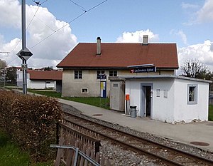 Single-story building with flat roof next to railway line