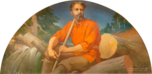 Man in pull over cotton shirt holding staff sitting on cut logs. Behind him is a river with logs piled up and sticking out as if in a log jam.