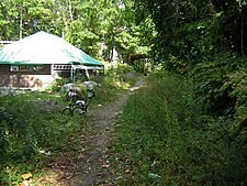 Before paving. Looking north past Bryn Mawr Park station replica, under Palmer Road, 2007