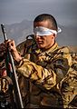 A soldier assembling and disassembling his gun parts with closed eyes