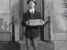 Tracy playing his accordion, from Romantic Melodies (1932)