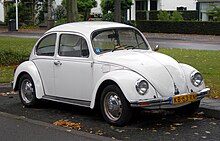 Front three-quarters-view of a white car with a compact body and small wheels