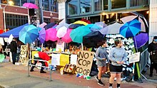 Outdoor market, protected by colorful umbrellas