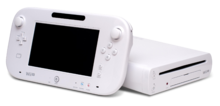 A white Wii U GamePad and its console, with the GamePad leaning against it