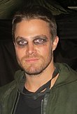 Stephen Amell, who portrays Oliver Queen, pictured on set in his Green Arrow costume in 2014