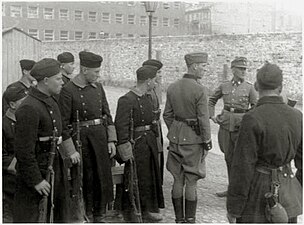 IPN copy #42 Askaris assigned to the operation Stroop and foreign fighters at the Umschlagplatz, with Stawki 5/7 in the back.