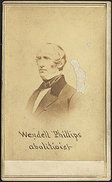 Photograph of Wendell Phillips with the caption "Wendell Phillips, abolitionist"; there is an abrasion on the right side of the image, above the subject's shoulder