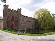 Mock castellated curtain walls and a fake moat