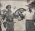 Commonwealth soldiers pose with a severed head inside a British military base in Malaya during the Malayan Emergency