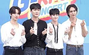 Lee Gikwang, Yoon Dujun, Yang Yoseob, Son Dongwoon standing from left to right, posing for press photos