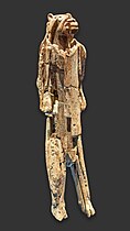 Tall figurine with a humanoid body and lion's head