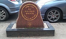 "a piece of brown marble inscribed: 'Here fell PC Malcolm Walker 4th October 2001 West Midlands Police', with a black stone base"