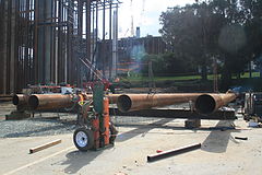 Falsework fabrication: Metalworkers fabricate a falsework section from pipe and beams.