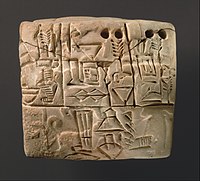 Proto-cuneiform tablet, Jemdet Nasr period, c. 3100–2900 BC. A dog on a leash is visible in the background of the lower panel.[3]