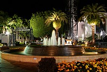 The Fountain of Fame and surrounding garden at night time.