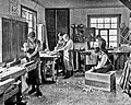 Image 26Students in a carpentry trade school learning woodworking skills, c. 1920 (from Vocational school)