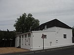 Free-standing single storey vernacular cottage with attic. Full hipped thatch roof; Victorian sashes (4 panes) to ground floor are probably replacements of original casements; double casement dormer windows new but single casement said to be original; Type of site: House Current use: House.