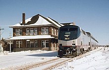 Blue and silver diesel locomotive in snow