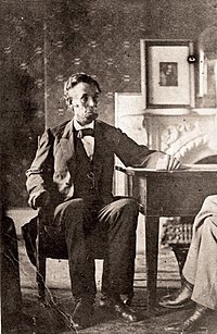 Lincoln seated at the table he uses as a desk