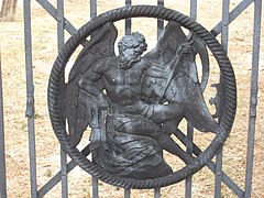 Detail of the "Father Time" medallion on the burial ground's wrought iron gates