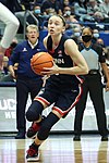 Alt=Paige Bueckers handling a basketball while in motion