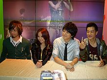 Three men and a female sitting at a table