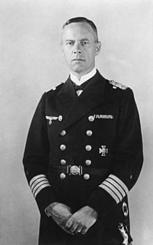 Black and white portrait photograph of Günther Lütjens in full naval uniform. He is looking, unsmiling, toward the photographer.