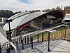 Picture of Cherrybrook station viewed from the outside. It consists of a curved roof covering a platform in a cutting below ground.