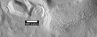 Dipping layers and layers of mantle, as seen by HiRISE under HiWish program. The dipping layers look similar to layers of mantle.