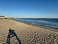 View of East Matunuck State Beach looking east from the first lifeguard chair. It shows the houses on the east end of the beach and the breakwater.