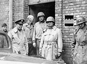Shown from left to right are: an unidentified driver, General George C. Marshall, Major General Horace L. McBride, Major General Manton S. Eddy, Lieutenant General George S. Patton, and an unidentified aide.
