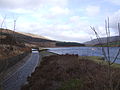 Image 14At the Rhodeswood reservoir dam, we see the outflow canal from the Torside Reservoir dam, alongside the Rhodeswood Reservoir. The Torside dam can be seen in the distance. To the right is Shining Clough Moss and Bleaklow. To the left Bareholm Moss and Black Hill (from Longdendale Chain)