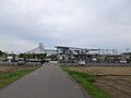 A distant view of the station, north entrance to the left, showing parking facilities.