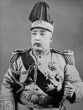 Black and white photo of a middle-aged man wearing a ceremonial military uniform