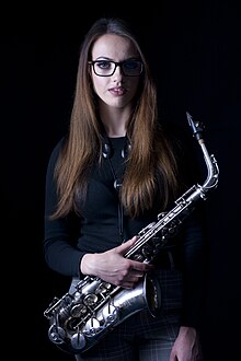 Young woman with an alto saxophone