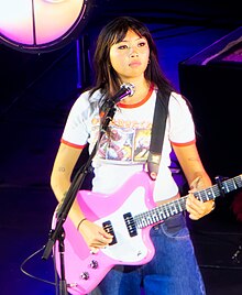 Beabadoobee onstage playing guitar