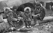 An Inuit family wearing traditional Caribou parkas.