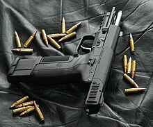 Photo of an all-black Five-seven USG with its slide locked back