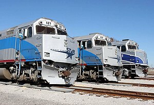 Three EMD F40PH locomotives in use by the WeGo Star lined up within the Lebanon, Tennessee yards. The third F40PH on the far right is a former Amtrak locomotive painted in its original Pacific Surfliner scheme which has since been repainted as of 2020.