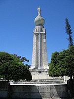 Cross on each side of the Monumento al Divino Salvador del Mundo pedestal]