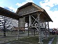 Roofed double hayrack with extension