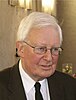 portrait of white-haired man with glasses