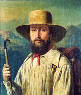 Peinture en couleur, portrait de face d'un homme jeune portant un ample chapeau beige, un foulard rouge noué au cou et une blouse couleur crème devant un paysage montagneux.