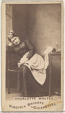 Woman sitting in chair leaning on elbow