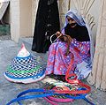 An elderly woman in Oman wearing the Battoulah.