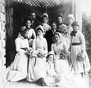 A group of people posing for a wedding photo