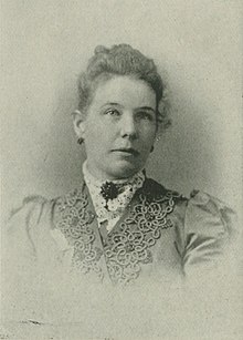 B&W portrait photo of a woman with her hair in an up-do