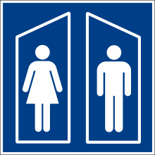 Toilet symbol with a person with a skirt and one without, in separate compartments.