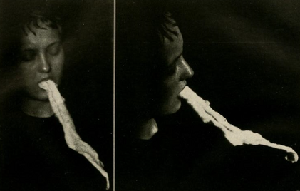 A spiritualist medium releasing ectoplasm, 1920